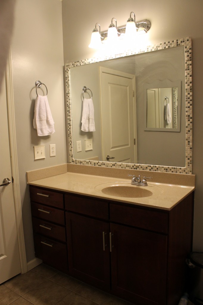 DIY Stick-On Mirror Frame  Mirror frame diy, Bathroom mirror frame,  Bathroom mirror makeover
