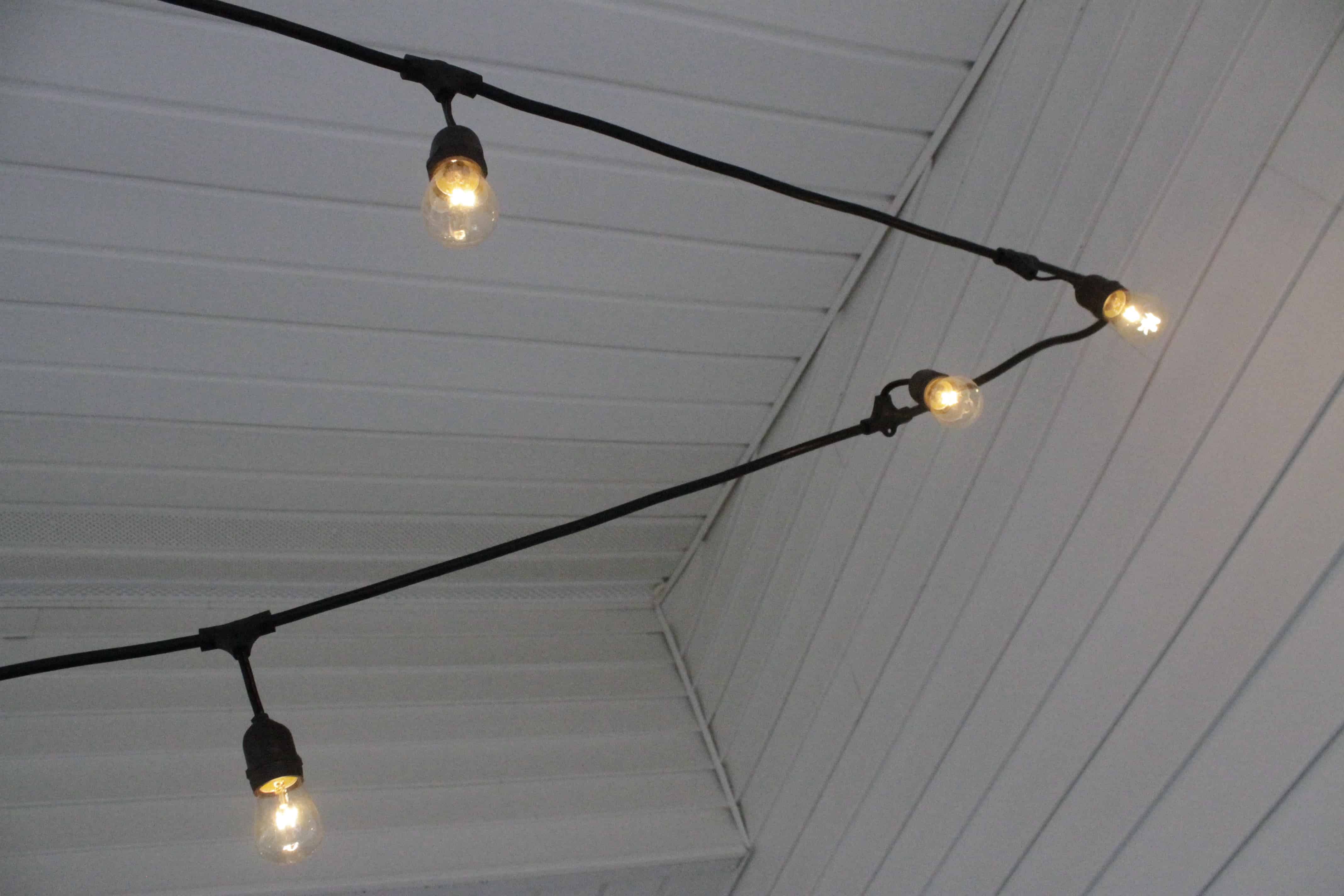 The Easiest Way To Hang String Lights On A Screened Porch