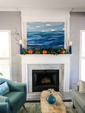 Simple Fall Mantel with pumpkins and greenery via Charleston Crafted