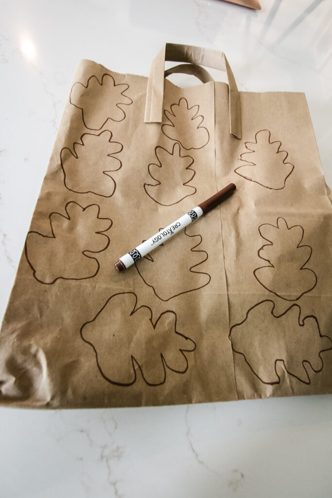 tracing leaves onto paper bags