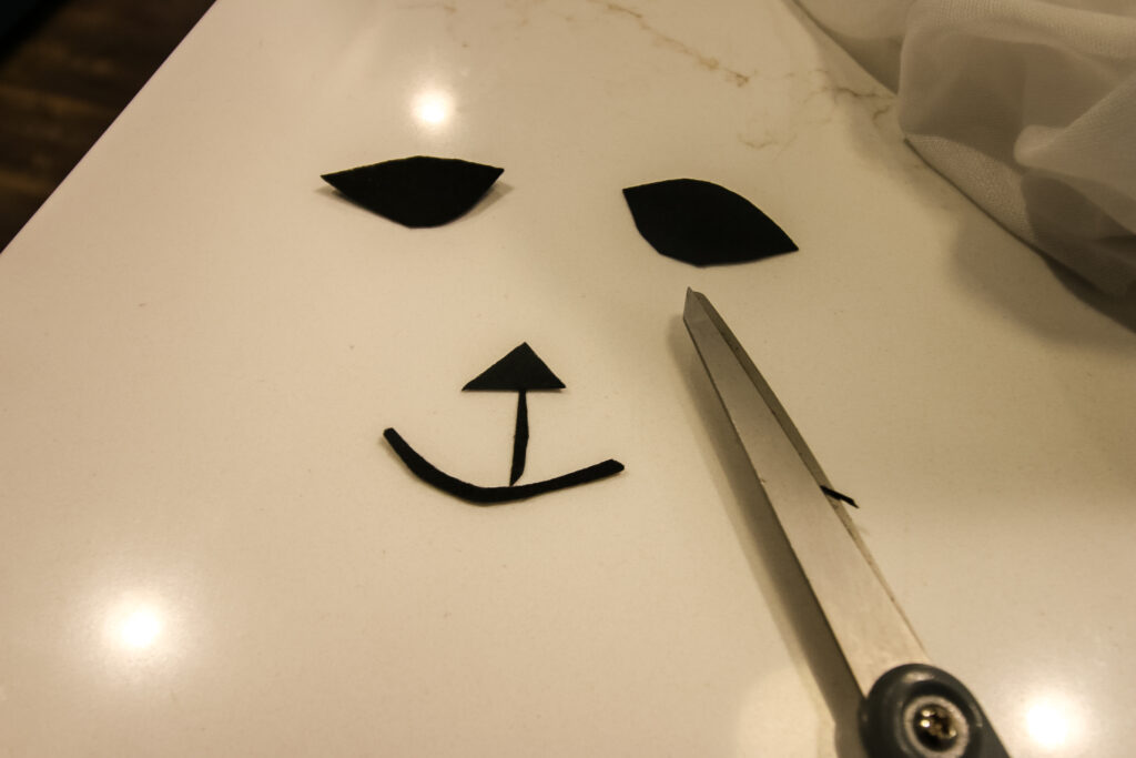 cutting felt faces for tomato cage ghosts