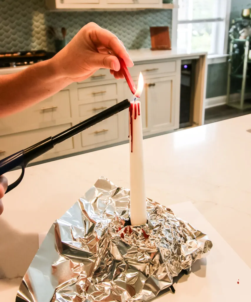 using melted crayons to create bleeding candles for halloween