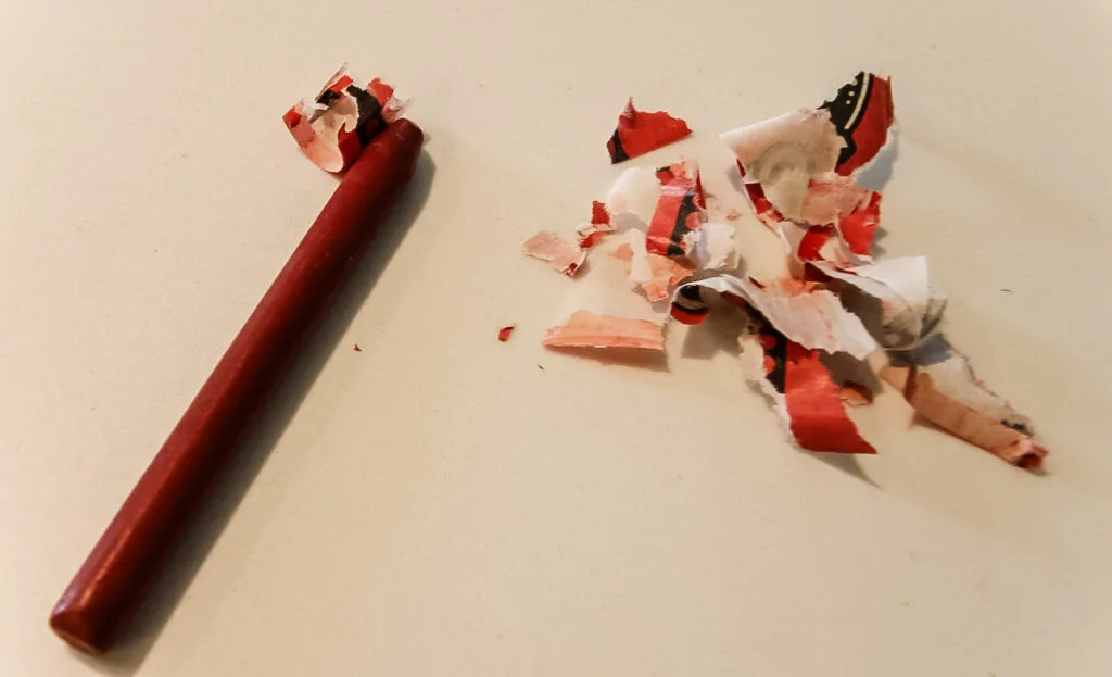 wrapper peeled off a red crayon