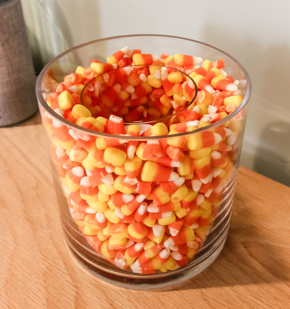 candle in a candy corn vase