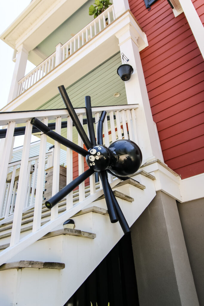 giant spider hanging from railing