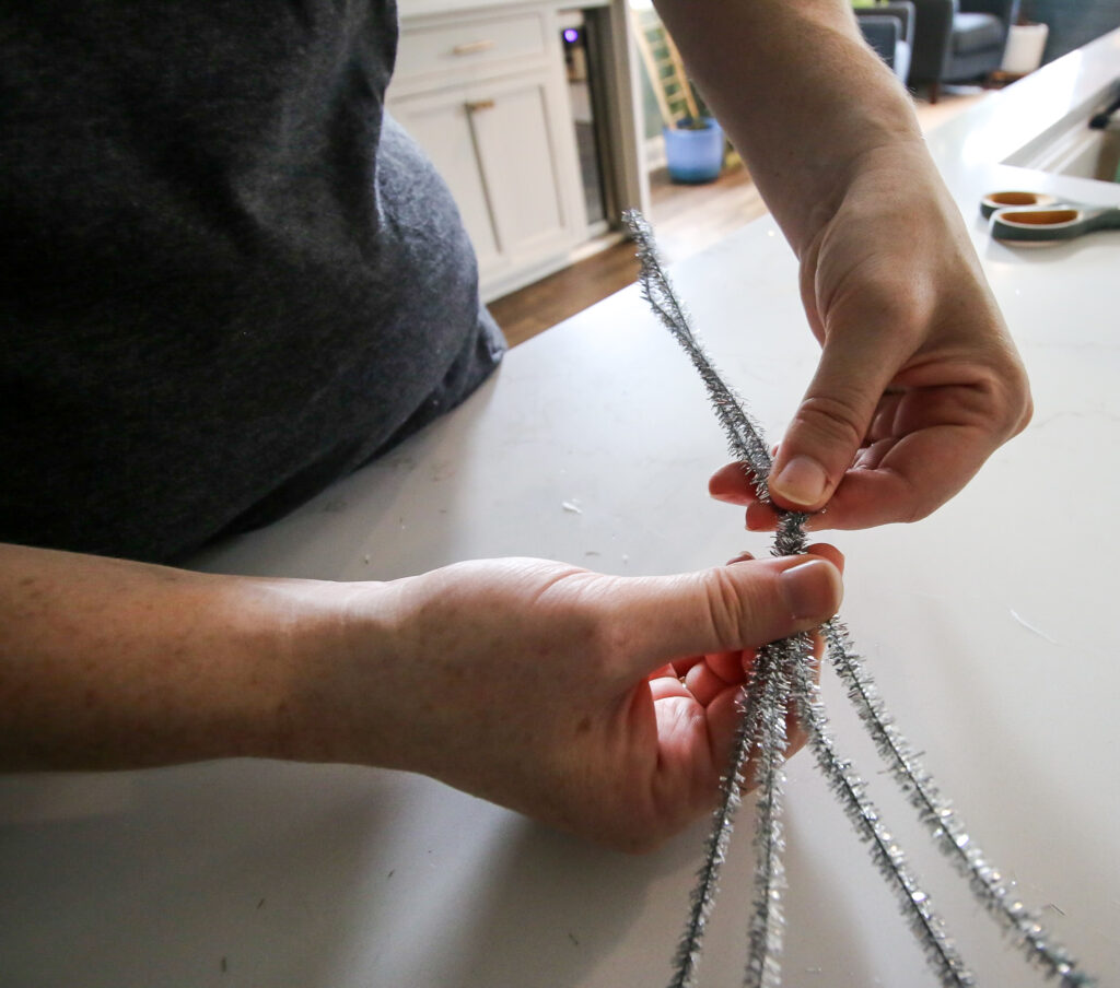 twisting pipe cleaners to make spider legs