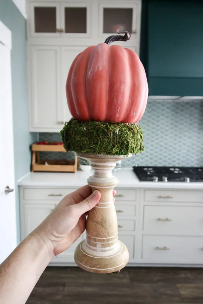 pumpkin glued on top of moss candlestick