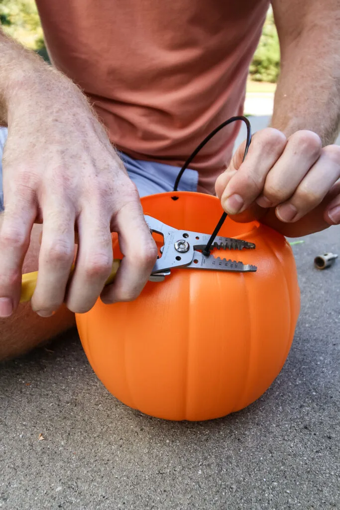 cutting the handle off a pumpkin bucket