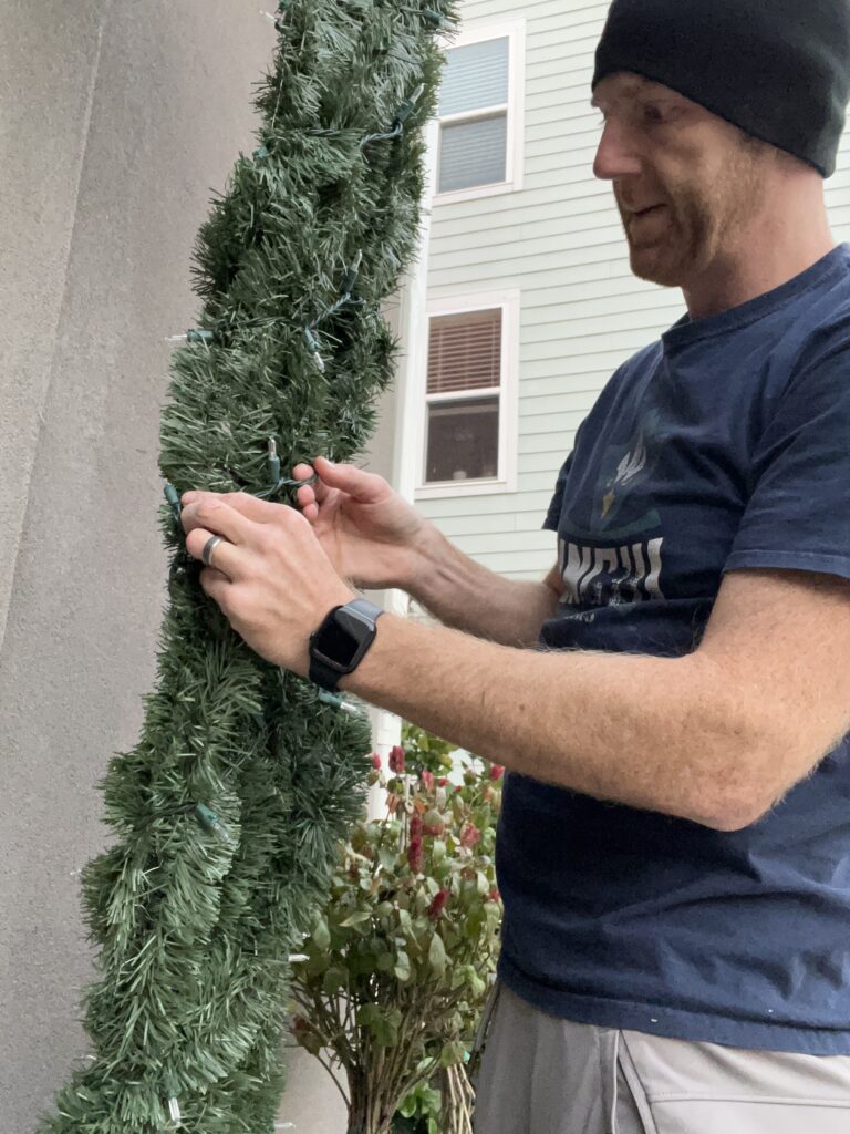 Wrapping string lights on garland