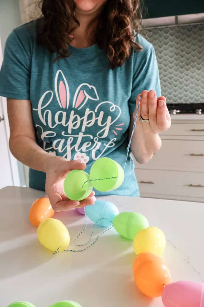 stringing easter eggs on string