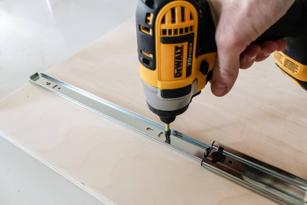 Screwing drawer slide into tray