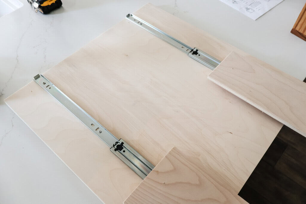 Drawer slides attached to underside of tray